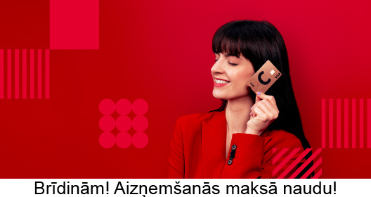 Девушка в красном наряде держит в левой руке карту Citadele C prime - цвета лавы. Предупреждаем! Займы стоят денег.