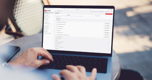 A person types on a laptop with the Citadele online bank open on the screen.