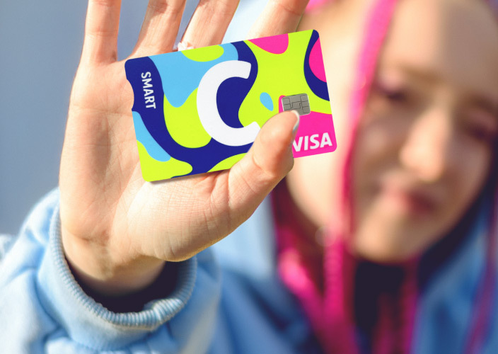 Citadele C smart NEON card with the word SMART, a large white letter C, and VISA logo. The card features a vibrant design in blue, green, yellow, and pink tones.