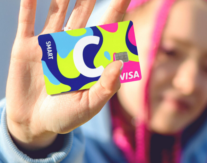 Citadele C smart NEON card with the word SMART, a large white letter C, and VISA logo. The card features a vibrant design in blue, green, yellow, and pink tones.