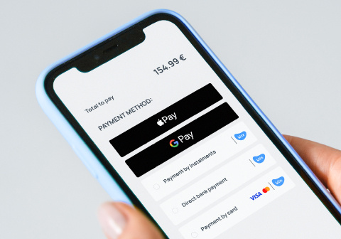 Online payment methods displayed on a smartphone, including Apple Pay and Google Pay.